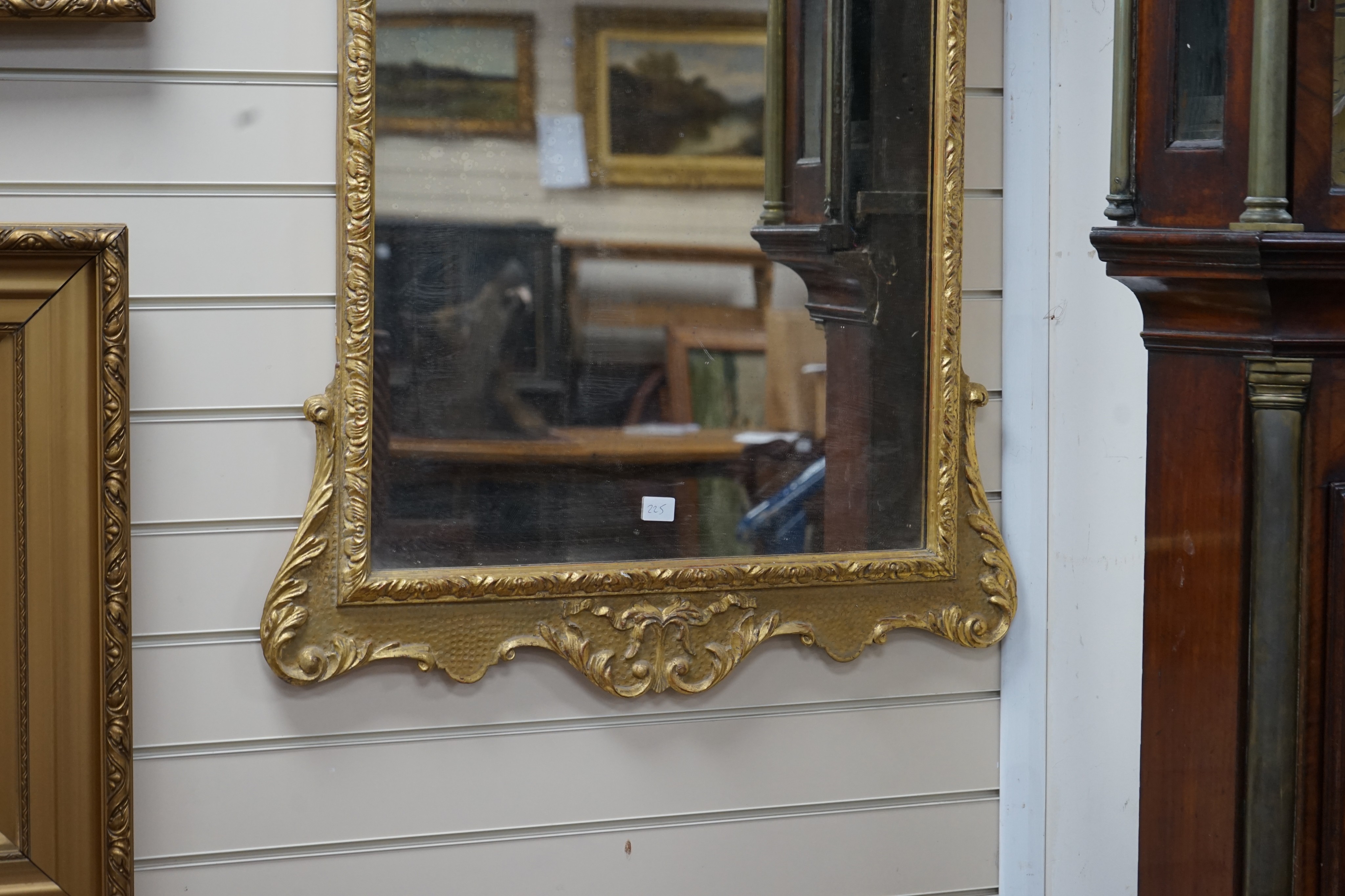 A George II style carved giltwood and composition wall mirror, width 76cm, height 135cm